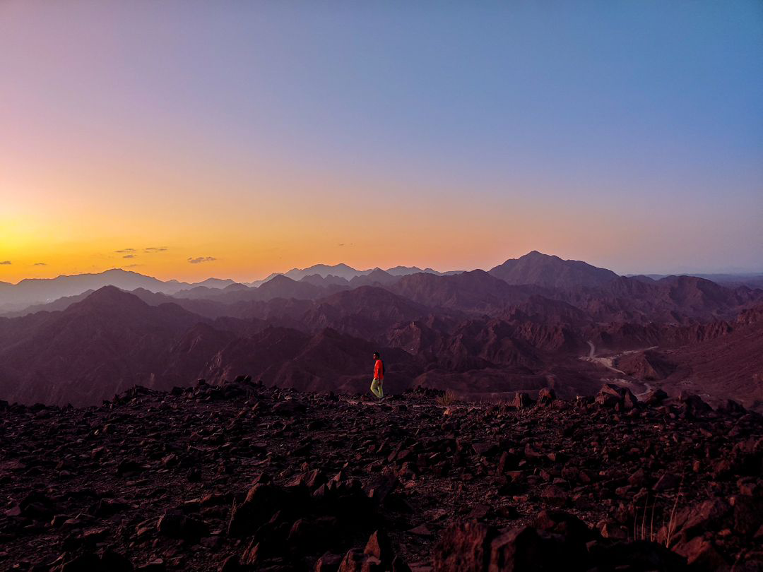 Lone figure on a high ridge at dusk — stand-in for Base Camp scale